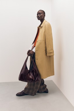 Tu-AW26-Model-12 - Ochre Textured PU Car Coat £48, Orange V-Neck Step-Hem Tank £16, Brown Heritage Check Trouser £22.50