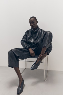 Tu-AW26-Model-29 - Black PU Batwing Funnel-Neck Bomber Jacket £40, Black PU Pull-On Barrel Trousers £24, Black Shoe Boot £25