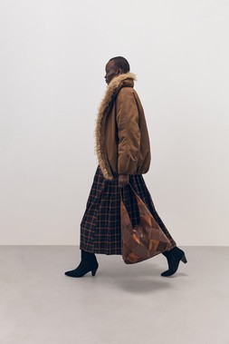 Tu-AW26-Model-37 - Slouch Shoulder Bag £24, Lambswool Envelope-Neck Jumper £38, Burgundy Check Kilt £28, Heel Boot £45, Bomber Jacket £48