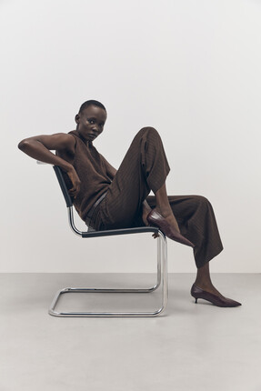 Tu-AW26-Model-02 - Brown Andres Tie-Neck Vest, £18  Brown Pinstripe Barrel Trousers, £25 Heeled Point Court Shoe, £22 